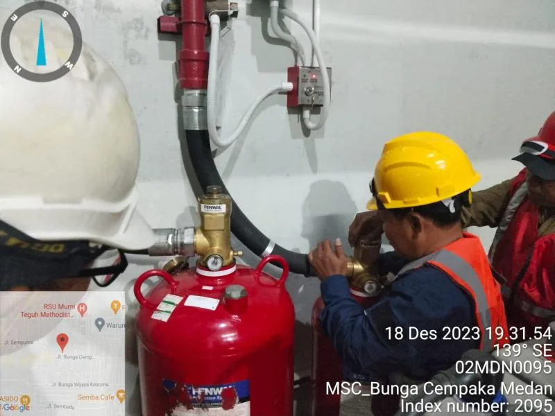 Teknisi mengerjakan instalasi sistem pemadam FM200 di ruang data center